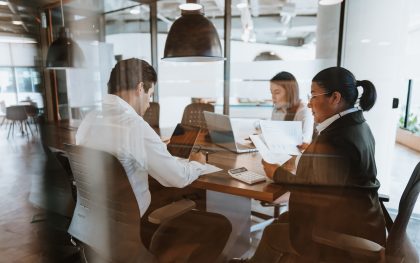Business meeting seen from behind window glass