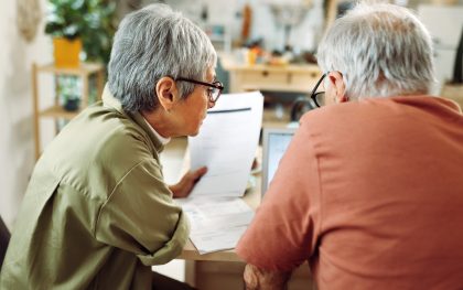 Senior couple going over bills at home